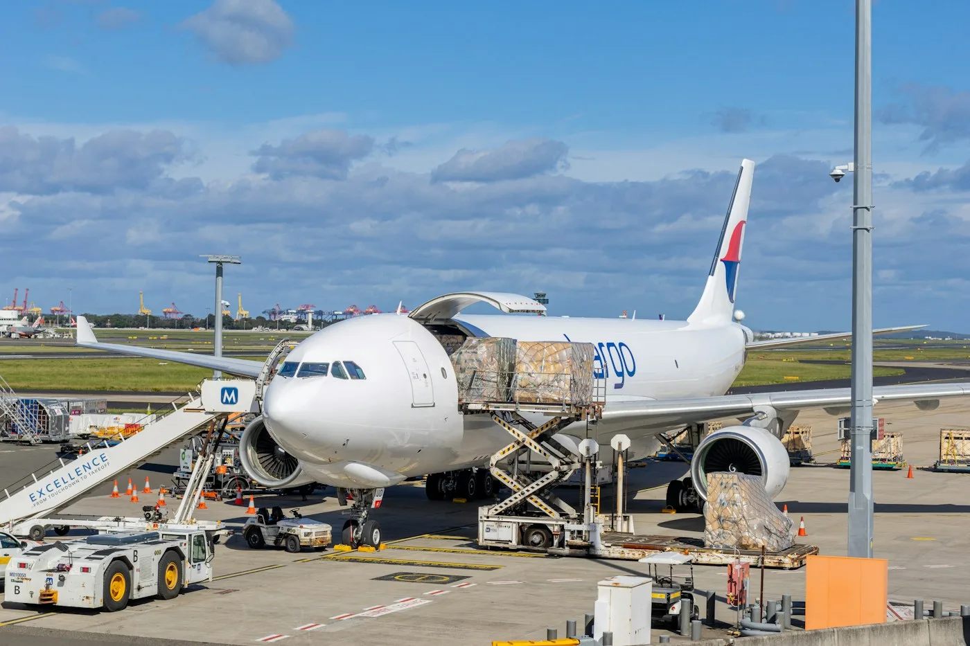 Cargo aircraft being loaded with air freight pallets at the airport